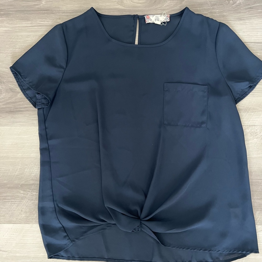Sheer blouse with knot at bottom and pocket. Size M